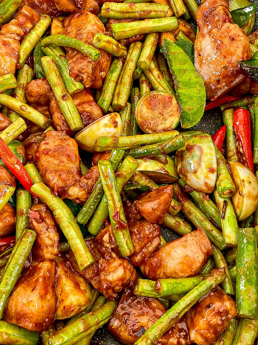 Close-up of pad prik king with pork, Thai eggplants, and yard long beans.