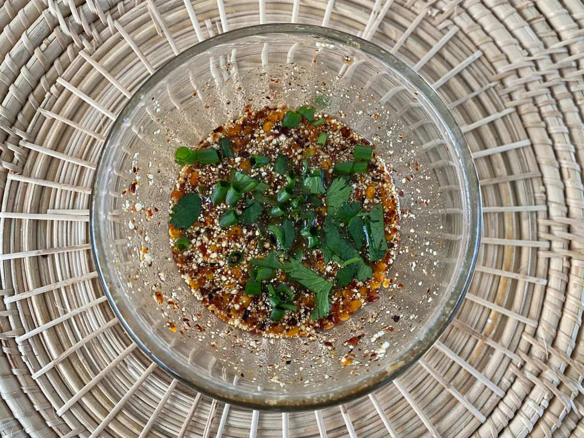 Top-down view of Thai chili dipping sauce in glass cup.