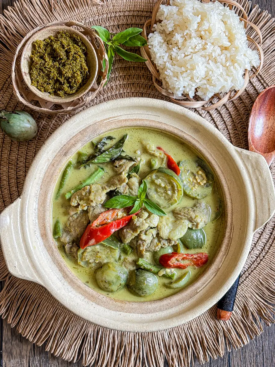 Gaeng keow wan, Thai green curry with pork, Thai eggplants, red chilies, and basil served with sticky rice.