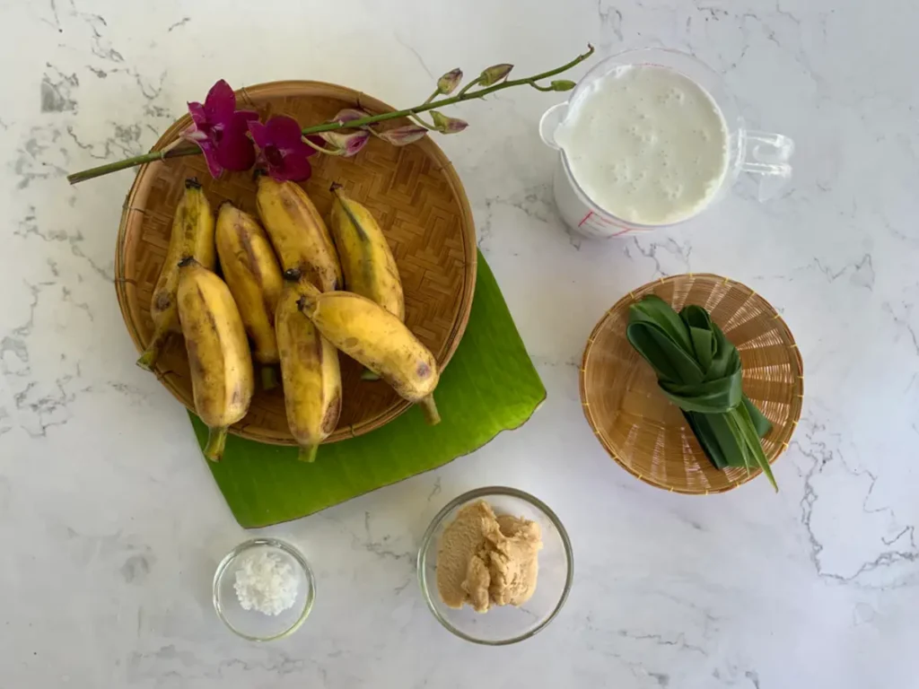 Ingredients for banana in coconut milk dessert: Thai bananas, salt, pandan, coconut milk, and palm sugar.