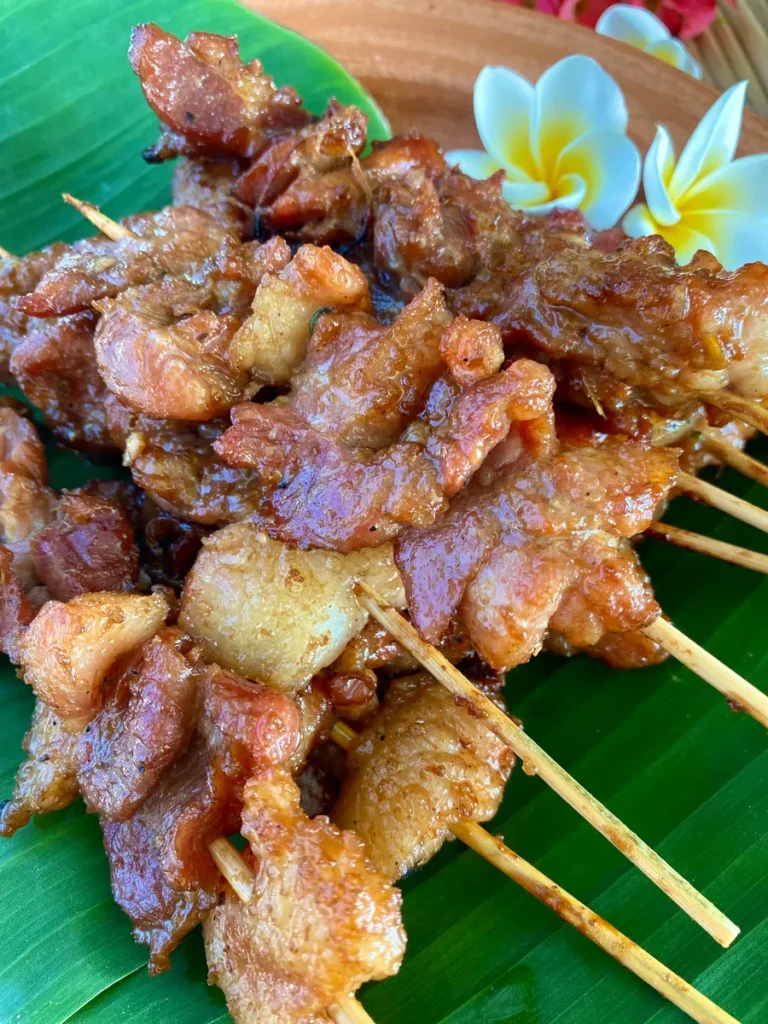 Close-up of moo ping, Thai pork skewers.
