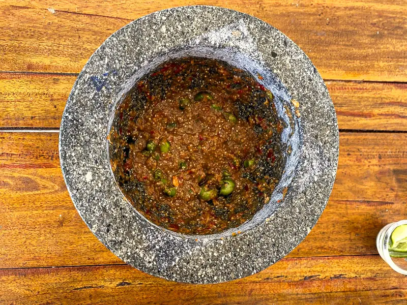 Top-view of nam prik kapi finished in stone mortar.