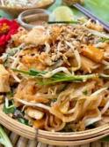 Close-up of pad Thai, highlighting the noodles coated with pad Thai sauce.