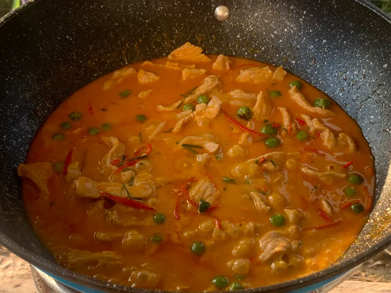Authentic panang curry prepared in a wok.