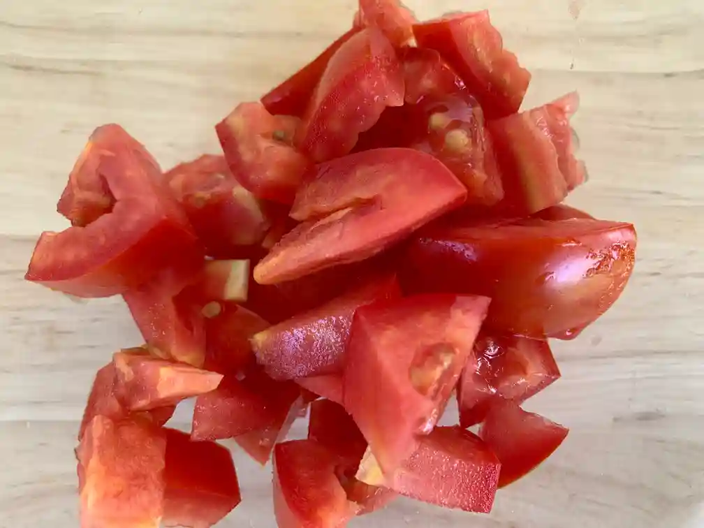 Sliced tomatoes on a cutting board.