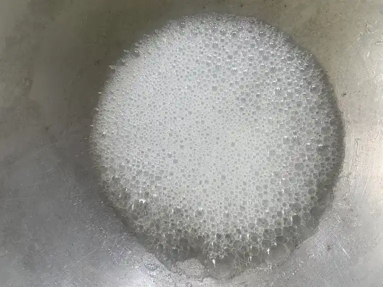 Sugar syrup cooking in a pan.