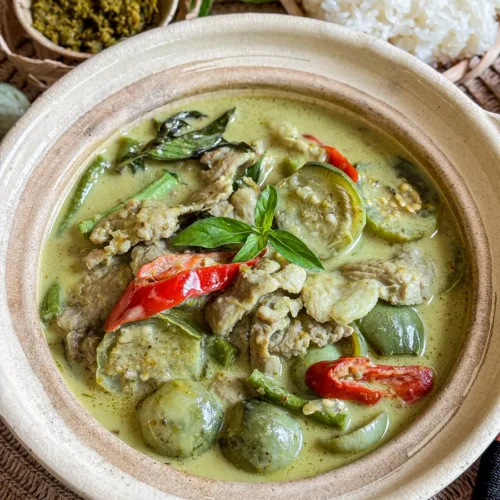 Authentic Thai green curry pork with eggplants and fresh basil.