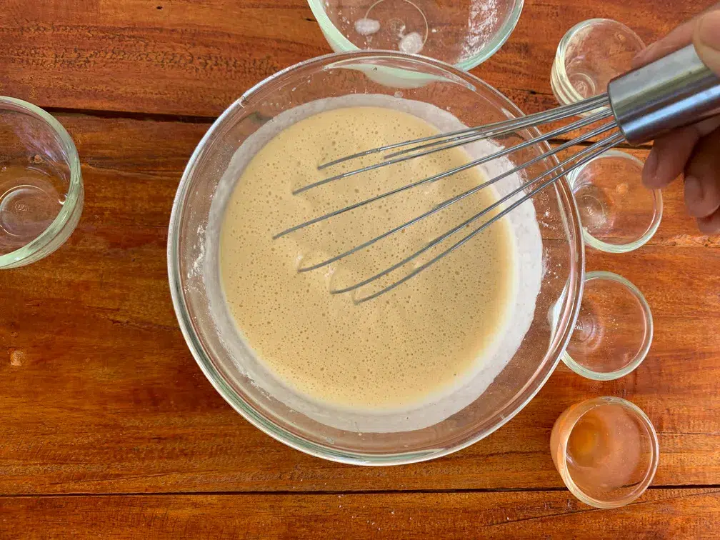 Batter mix for fried chicken in a glass bowl.