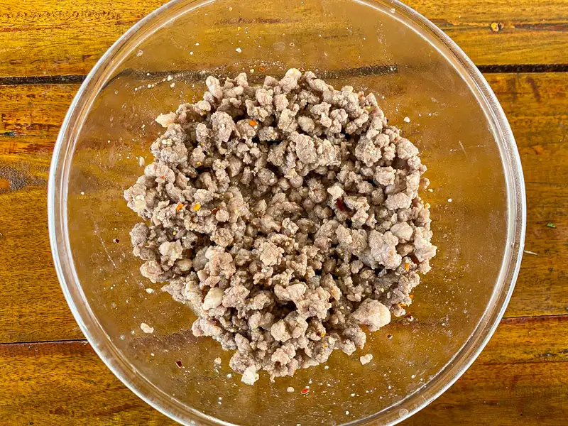 Cooked ground pork in a bowl.