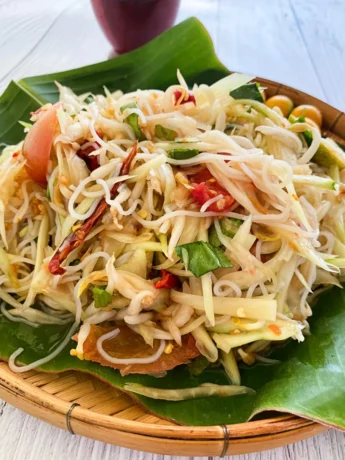 Tam sua, Thai papaya salad, with vermicelli noodles, chilies, and lime.