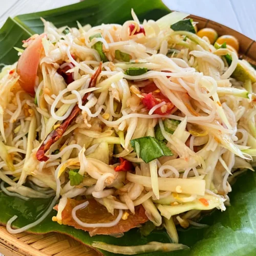 Tam sua, Thai papaya salad, with vermicelli noodles, chilies, and lime.