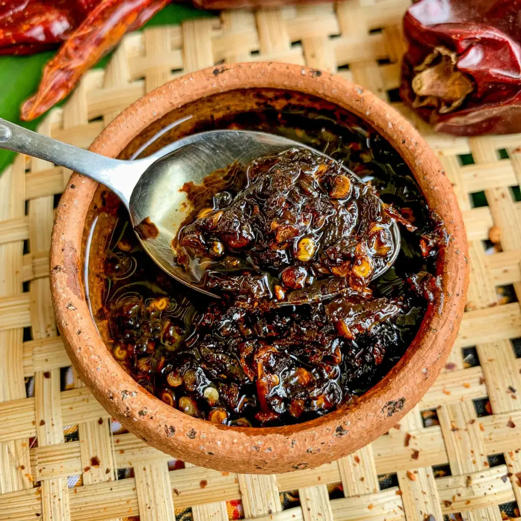 Close-up of Thai chili oil in a clay sauce cup.