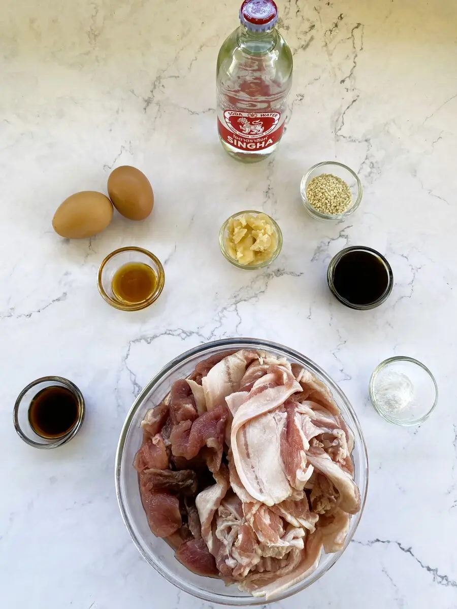 Ingredients for Thai-style marinade: oyster sauce, golden mountain sauce, sesame oil, palm sugar, sesame seeds, eggs, baking powder, and sparkling water.
