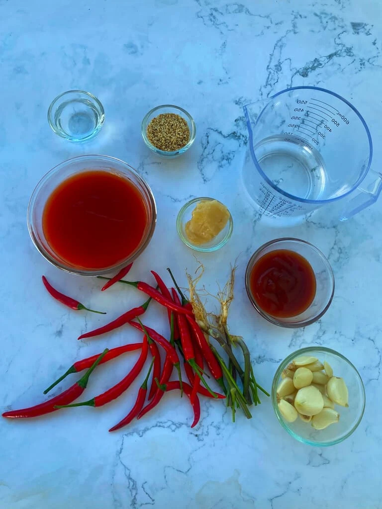Ingredients for mookata chili sauce on a white background.