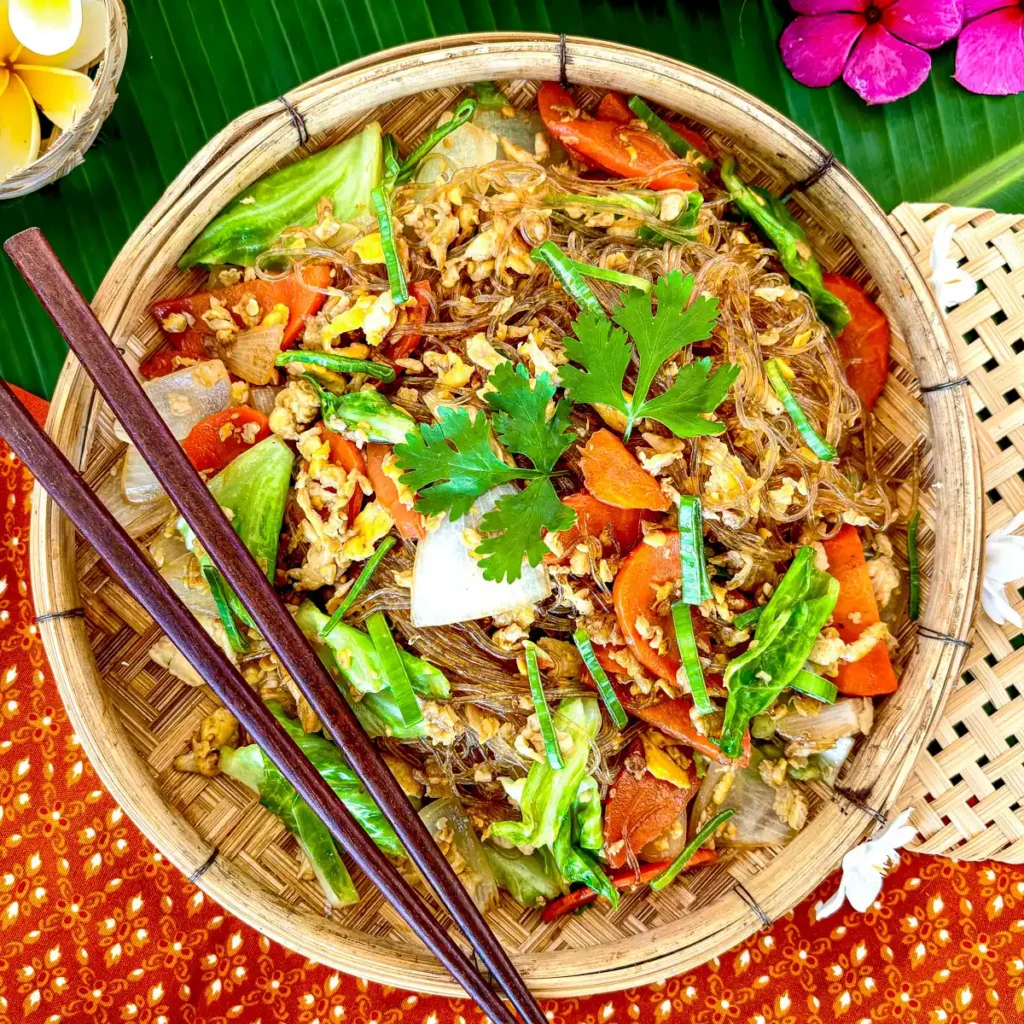 Pad woon sen, Thai glass noodle stir-fry served in a traditional bamboo dish.