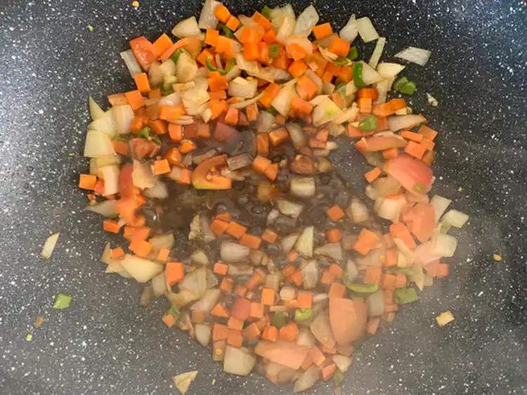 Stir-fried vegetables with seasonings in a wok.