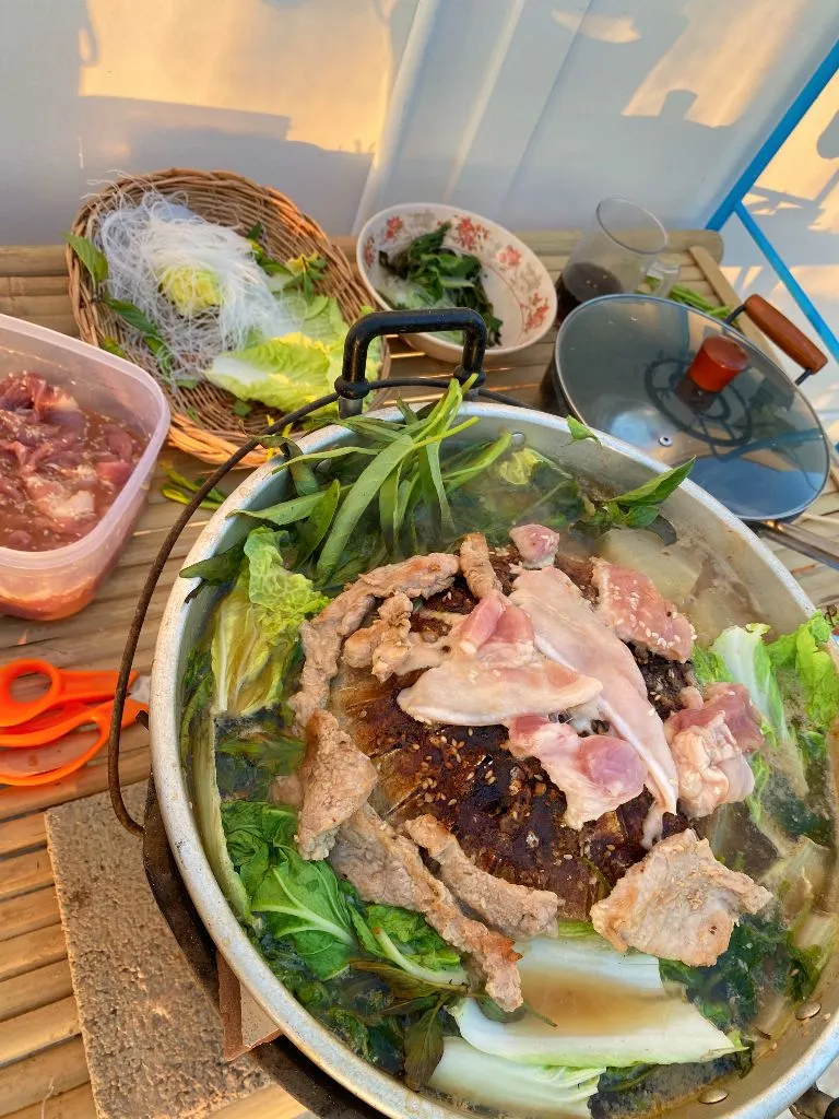 Thai BBQ mookata with glass noodles, vegetables, soup base, marinade, and meat.