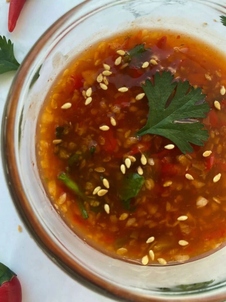 Thai mookata sauce in a clear cup.