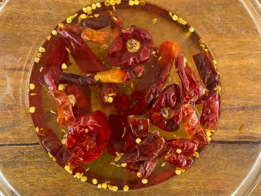 Close-up of dried chilies in water.