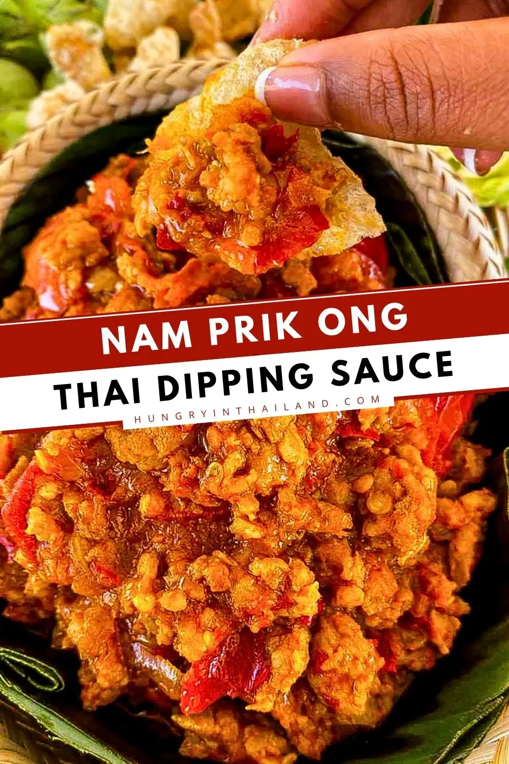 Hand dipping crispy pork crackling into authentic nam prik ong, a Northern Thai pork and tomato chili dip.