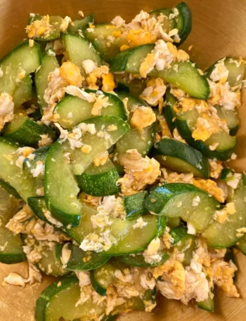 Close-up of Thai cucumber and egg stir-fry in a wok.