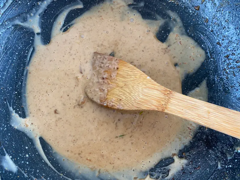 Creamy Thai garlic pepper sauce cooking in a wok.