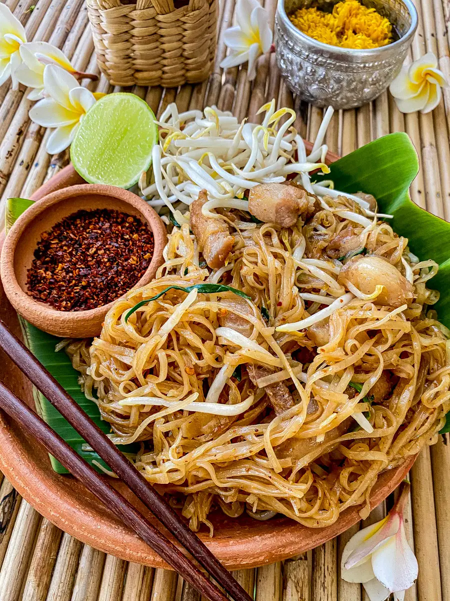 Authentic pad mee korat served with pork belly, bean sprouts, lime, and Thai chili flakes.