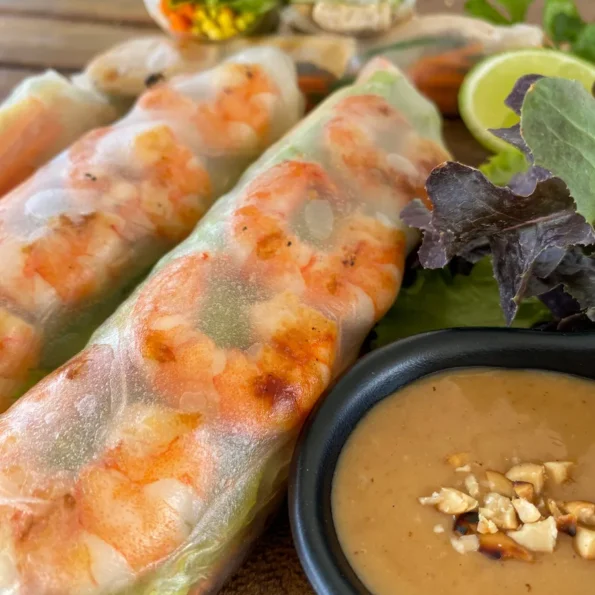 Fresh Thai shrimp rolls with peanut sauce topped with crushed peanuts.