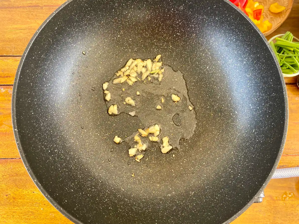 Wok pan with sautéed garlic.