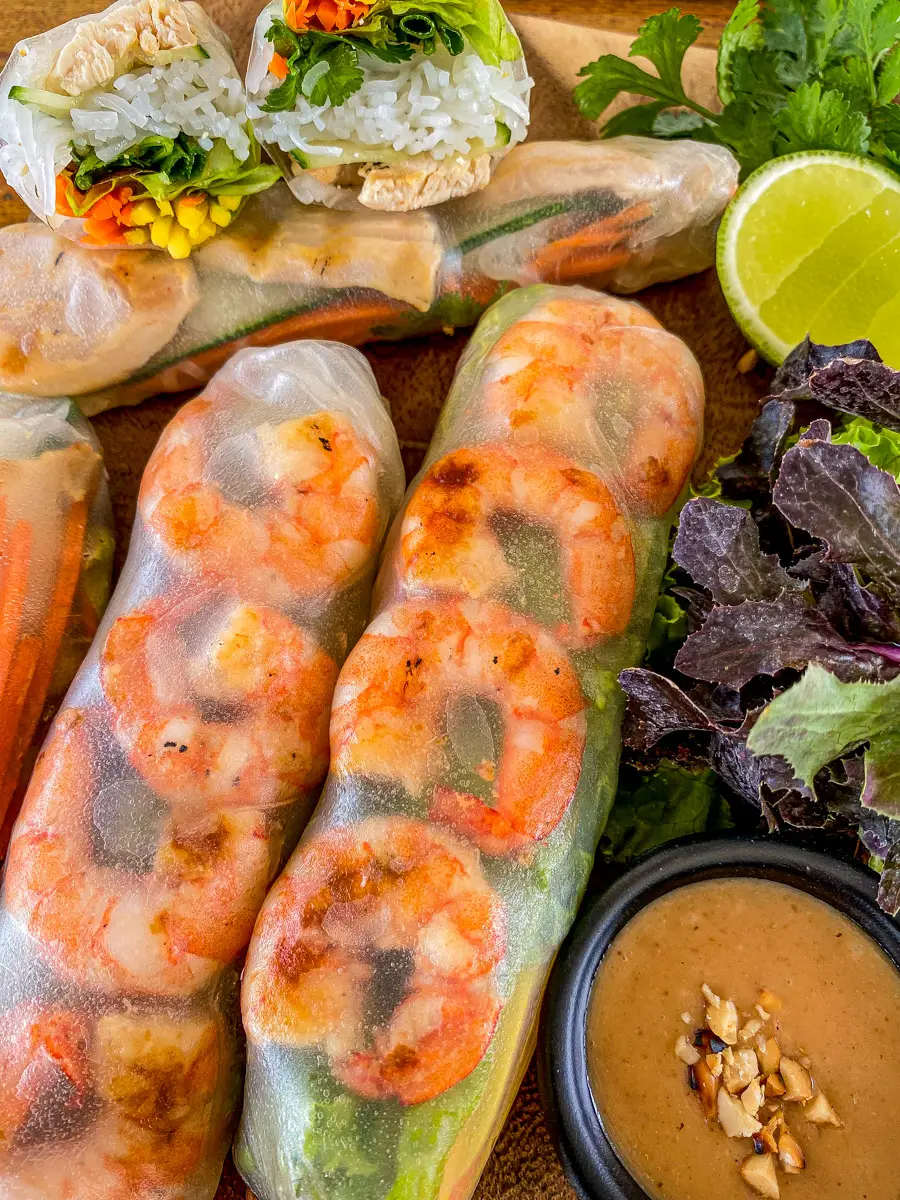 Thai shrimp rice paper rolls with crisp veggies and rice noodles, paired with a smooth peanut sauce and fresh lime.