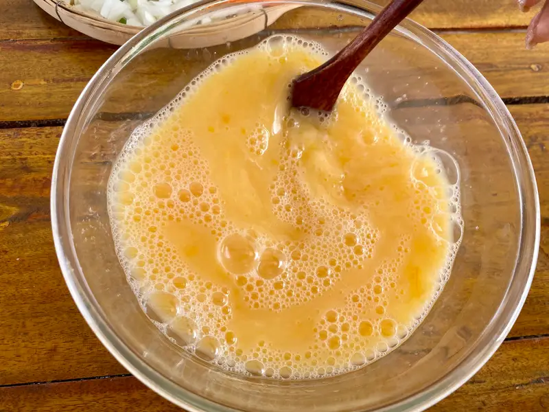 Whisked Thai steamed egg mixture with water, soy sauce, and white pepper before steaming.