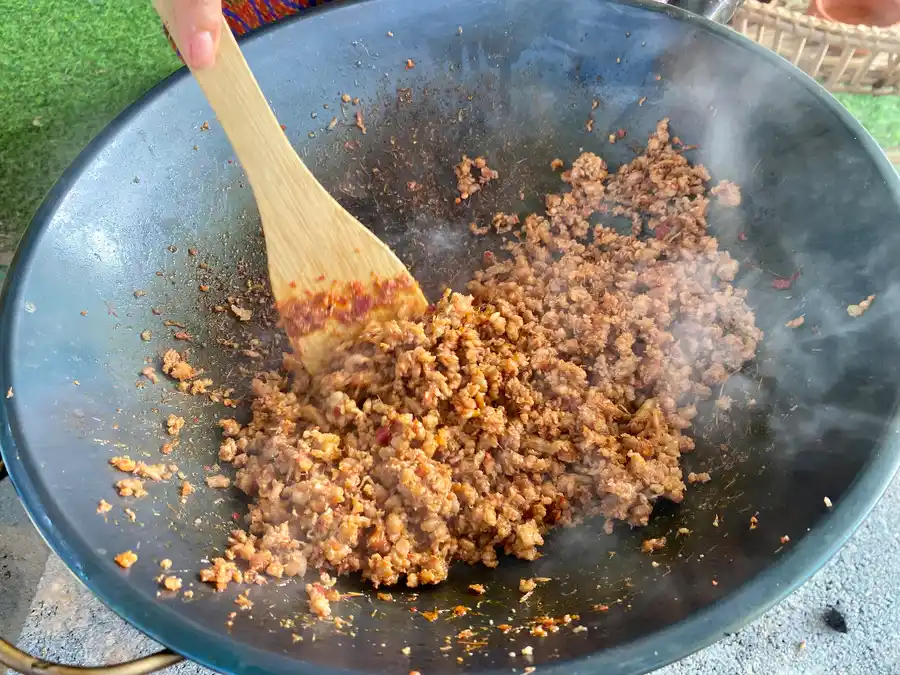 https://hungryinthailand.com/wp-content/uploads/2023/04/added-flavoring-to-kua-kling-in-a-wok.webp
