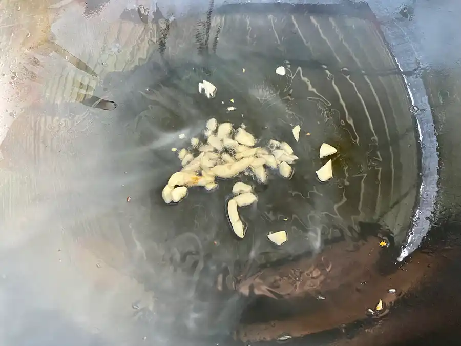 Close-up of golden fried garlic in a wok.