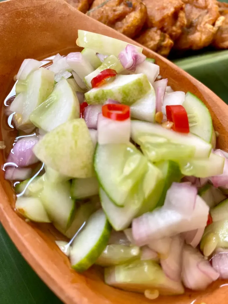 Thai cucumber salad for satay in a clay cup.