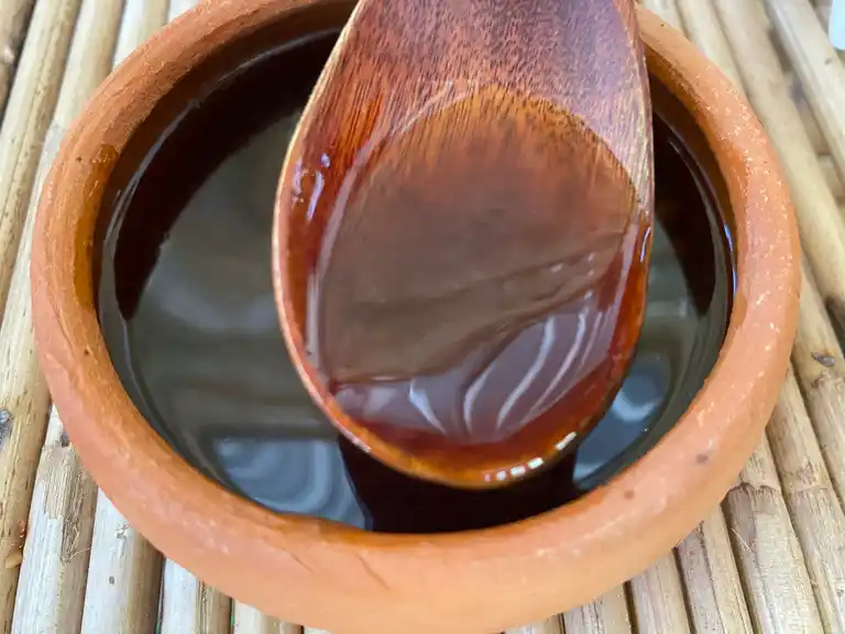 A mix of Thai sauces and seasonings in a clay bowl.