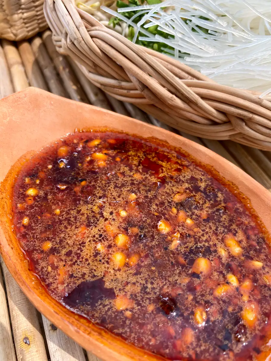 Tom yum sauce in a clay bowl.