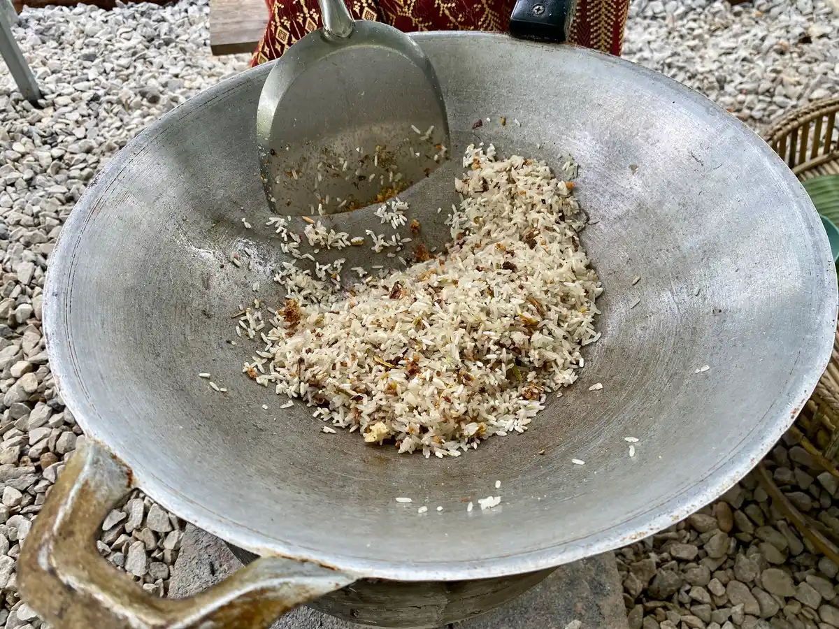 Rice being fried in a wok.