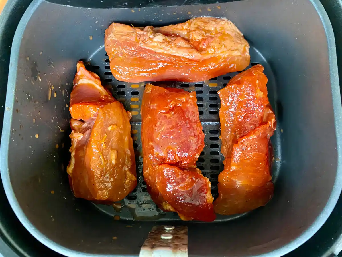 Close-up of red pork in an air fryer.