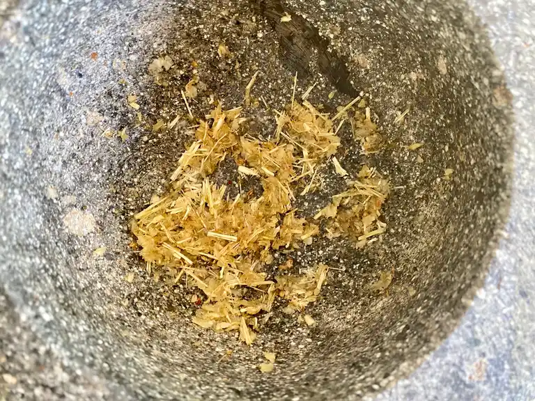 Crushed spices in granite mortar.
