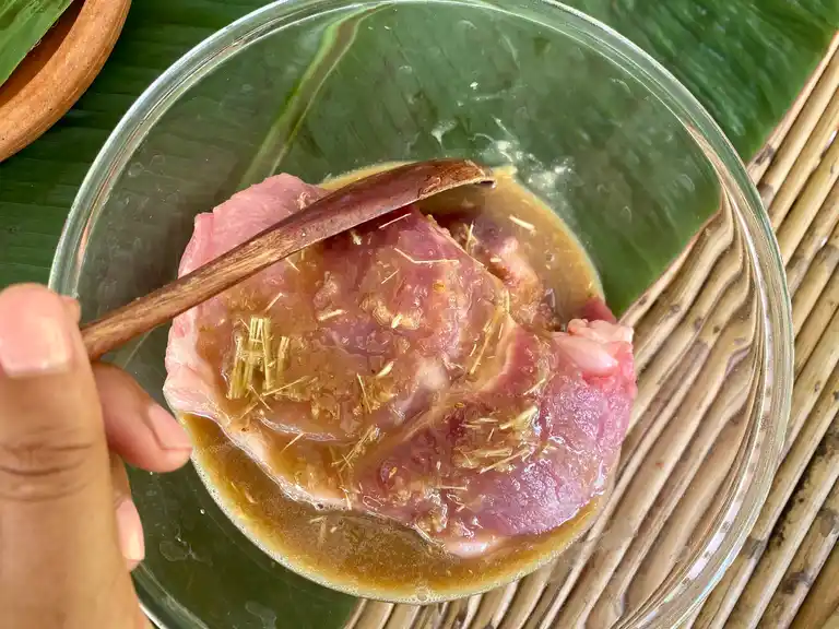 Thai marinated pork in a glass bowl.