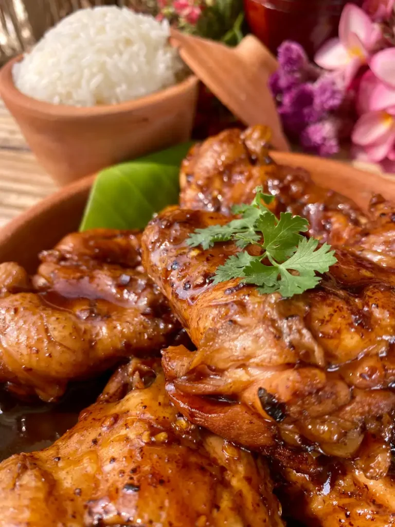 Close-up of Coca-Cola chicken wings with white rice.