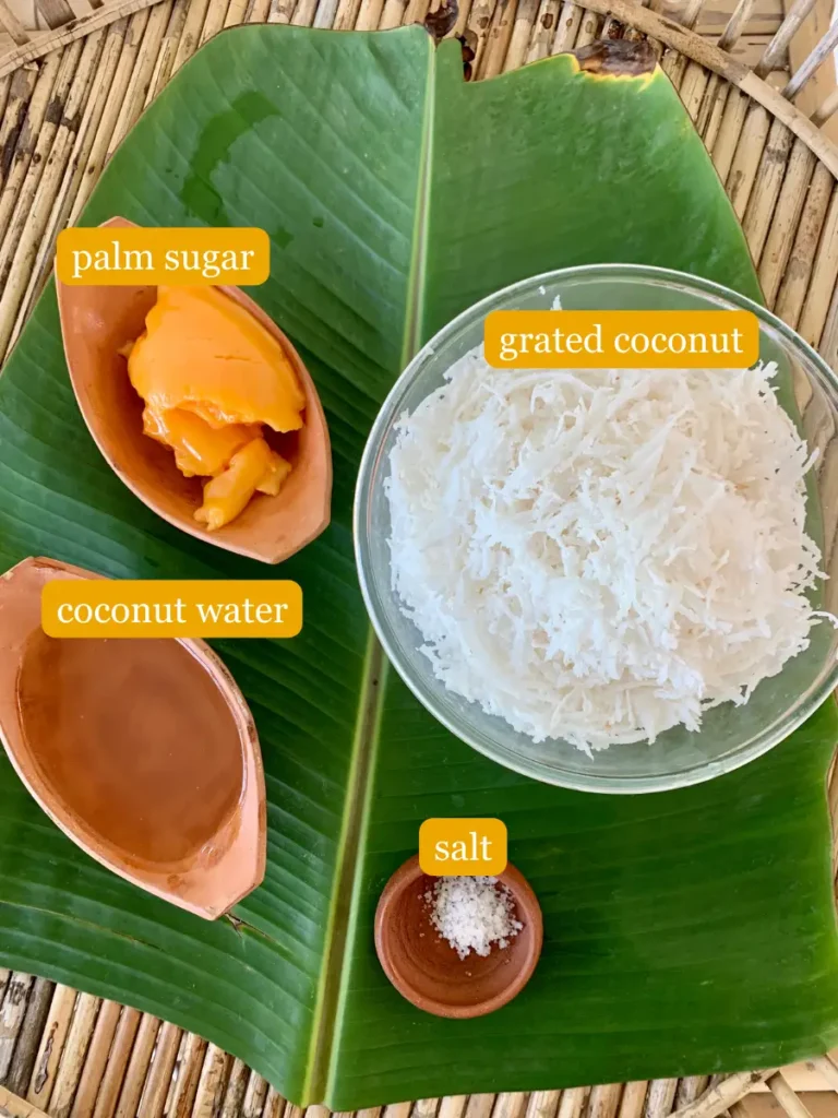 Bird's eye view of coconut filling ingredients; palm sugar, grated coconut, coconut water, and salt.