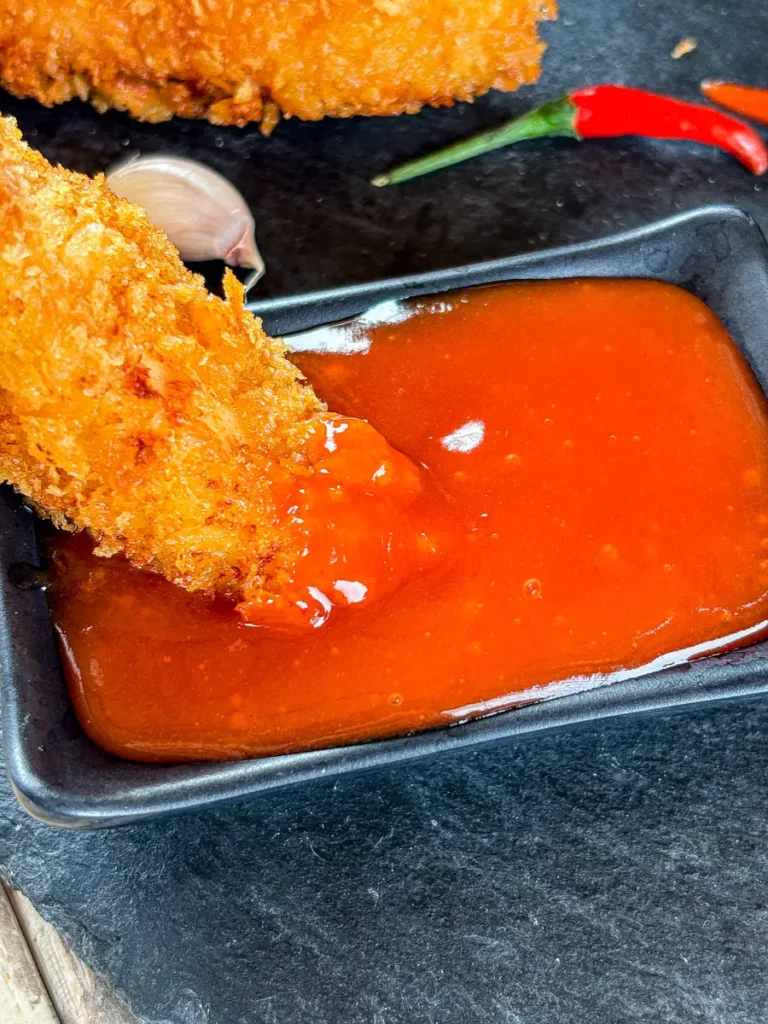 Crispy fried chicken strip dipped into homemade Thai chili hot sauce.