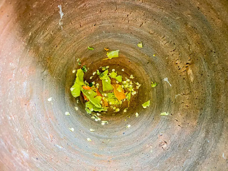 Top-view of crushed chilies in a mortar.