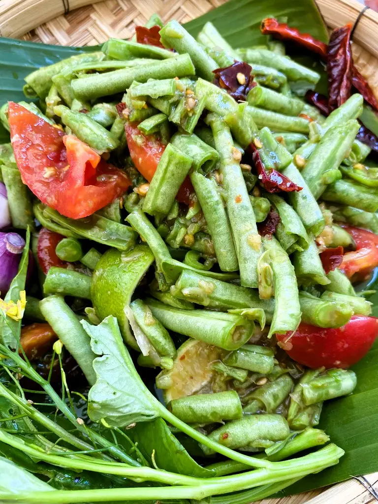 Thai long bean salad with yardlong beans, tomatoes, and Thai spices, ready to enjoy.