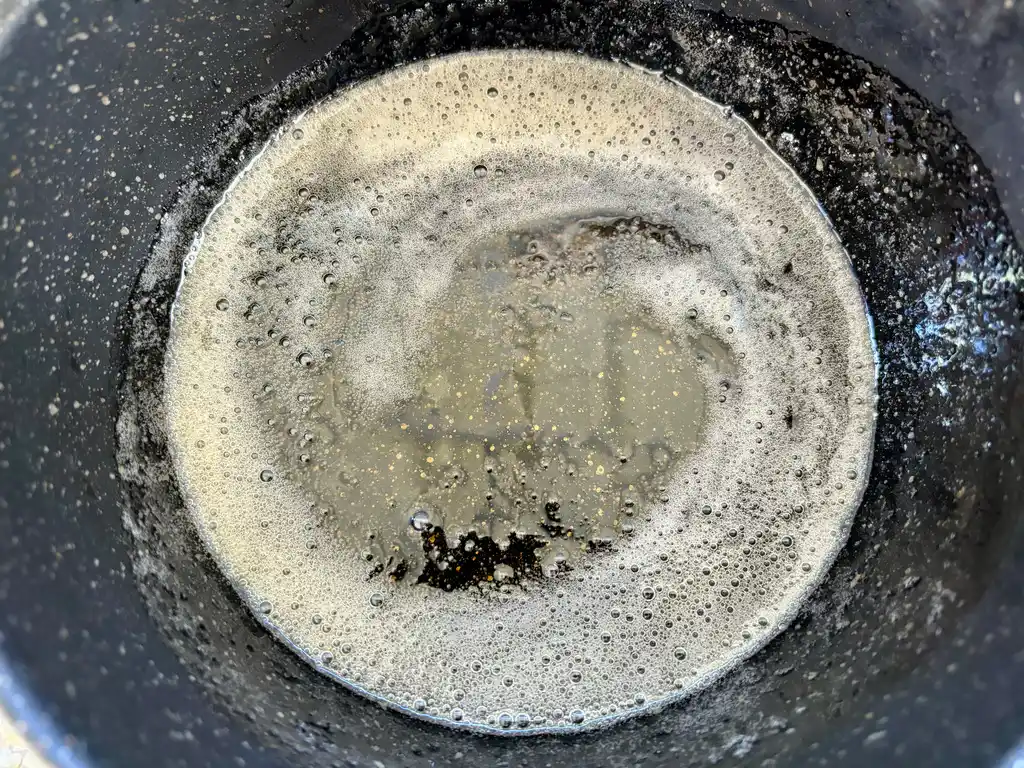 Preparation of caramel sauce in a pot.