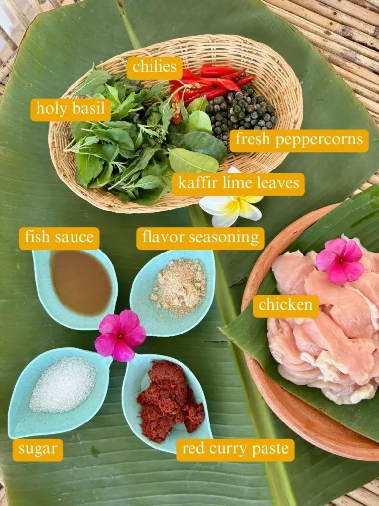 Ingredients for Thai chicken pad ped recipe: holy basil, kaffir lime, fresh peppercorns, red curry paste, fish sauce, and sugar.