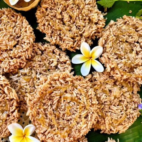 Khao taen, Thai crispy rice cakes, displayed on a green banana leaf.