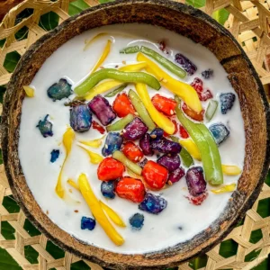 Ruam mit, a Thai dessert with tapioca pearls and coconut milk, served in a coconut shell.