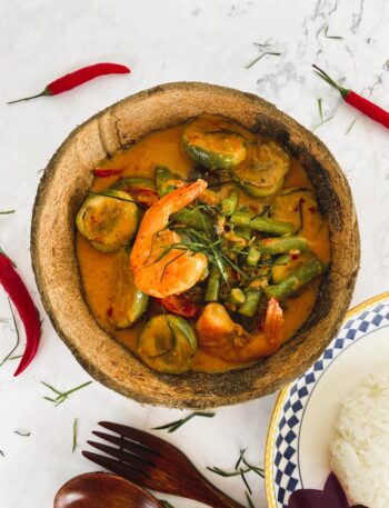 Authentic Thai red curry served in a coconut shell.
